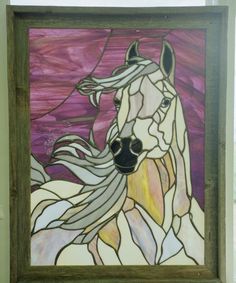 a stained glass window with a horse on it's face and long manes