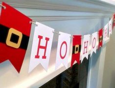 a christmas banner hanging from the side of a fireplace