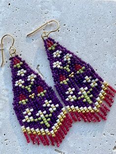 Purple yarrow seed bead fringe earrings on gold-plated, nickle free, earwires. Handmade and designed by Beading Down South.©️ Bohemian Festive Beaded Tassel Earrings, Handmade Purple Bohemian Tassel Earrings, Handmade Bohemian Purple Tassel Earrings, Purple Bohemian Handmade Tassel Earrings, Bohemian Flower Earrings With Dangling Beads, Bohemian Gold Beaded Flower Earrings, Earwires Handmade, Folk Flowers, Beaded Patterns