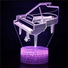 an illuminated piano is shown in the dark with purple lighting on it and a black background