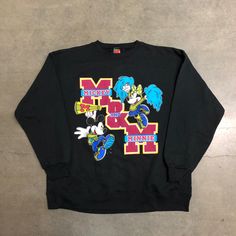 Vintage 90’s Disney Mickey & Minnie Mouse Varsity Graphic Sweatshirt Adult Medium-Large (See Below For Measurements) From The 90’s Era Made In Usa Black Cotton Blend Crewneck Huge Mickey And Minnie Mouse Variety Style School Graphic Print In Great Condition. Very Clean. Appears To Be Unused Judging By The Minimal Wear On The Inside But May Be Very Lightly Worn. No Major Fading On The Colors, No Rips Or Holes On The Fabric. No Stains. No Cracking On The Graphic Print Measurements: Pit To Pit: 23 Mickey Mouse Long Sleeve T-shirt For Streetwear, Black Mickey Mouse Sweatshirt For Streetwear, Mickey Mouse Crew Neck Top For Streetwear, Casual Mickey Mouse Sweatshirt For Streetwear, Mickey Mouse Cotton Tops For Streetwear, Retro Mickey Mouse Top For Streetwear, Mickey And Minnie Mouse, Mickey And Minnie, Mickey Minnie Mouse