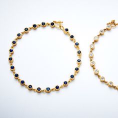 The Meadow Blue Sapphire Bracelet is a modern take on the classic design that looks beautiful from every angle! This unique and delicate handmade chain is remarkable on its own or layered with other bracelets. 20K Peach Gold Round Blue Sapphires: 3.1mm, 2.3 ctw Bracelet measures 7.5" Style Number: BP200LBSX Hand fabricated in our New York City design atelier & workshop Elegant Blue Gold-plated Bracelets, Elegant Blue Bracelets With Adjustable Chain, Elegant Handmade Sapphire Bracelets, Blue Sapphire Bracelet, Design Atelier, Handmade Chain, Sapphire Bracelet, The Meadows, City Design