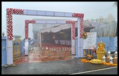 an entrance to a wedding venue with flowers and decorations on the ground in front of it