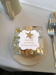 a plate with a star on it next to a cup and fork