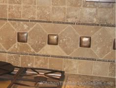 a stove top oven sitting inside of a kitchen next to a tiled backsplash