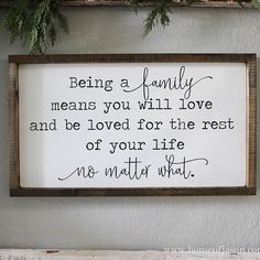 a framed sign that says being a family means you will love and be loved for the rest of your life no matter what