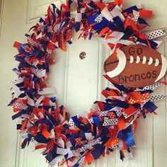 a football wreath is decorated with red, white and blue streamers that read go bronco's