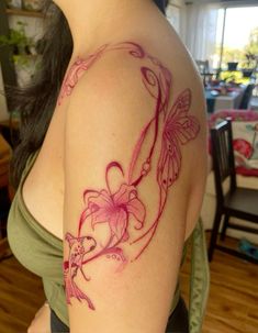 a woman with a tattoo on her arm has a butterfly and flower in the shape of a circle