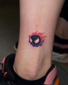 a person with a small tattoo on their leg that has a penguin in the center