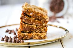 a stack of chocolate chip bars sitting on top of a white plate