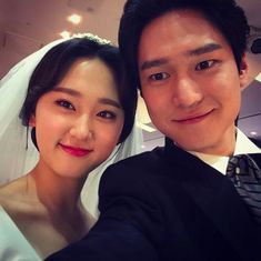 a bride and groom taking a selfie together