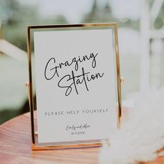 a sign that says, greeting station please help yourself on the side of a wooden table