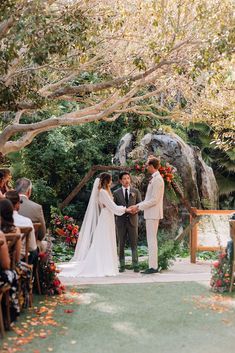 a bride and groom standing at the end of their wedding ceremony