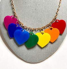 7 Heart Acrylic Rainbow Statement Necklace.  This is truely a unique and bold statement necklace. Hearts measures 1.25 inches.  The chain measures 18 inches and is antique copper colored with a lobster clasp.   Each piece of jewelry is designed, hand-cut, assembled by me. Heart Rainbow, Acrylic Necklace, Bold Statement Necklaces, Acrylic Necklaces, Shop Name, Rainbow Jewelry, Bib Necklaces, Unicorn Rainbow, Charm Necklaces