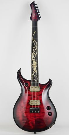 a red and black guitar sitting on top of a table