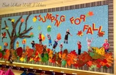 a bulletin board with children's fall leaves on it