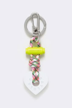 a keychain with a neon yellow handle and two colorful ropes attached to it