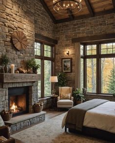 a bedroom with a stone fireplace and large windows