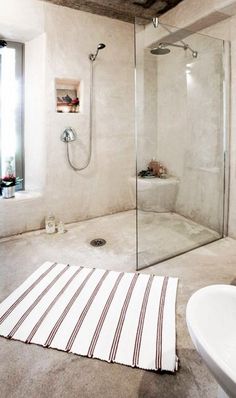 a bathroom with a sink, shower and bathtub next to a window in it