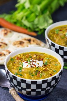 two bowls filled with soup and topped with sour cream, garnished with parsley