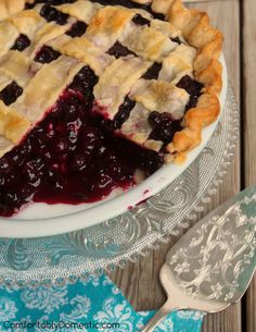 a blueberry pie on a plate with a fork