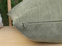 a green pillow sitting on top of a wooden table