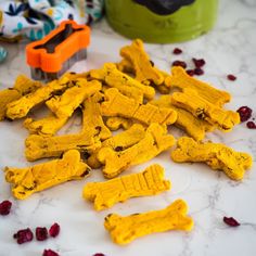 yellow dog treats are on the counter with cranberries and other things around them