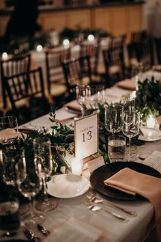 the table is set with place settings and candles