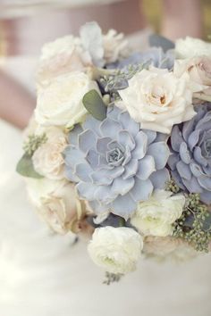 a bridal bouquet with white and blue flowers