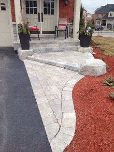 a brick walkway leading to the front door of a house