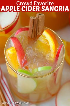 an apple cider sangria is garnished with cinnamon and apples