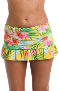 Built-in bikini bottoms ensure you feel confident while you lounge by the water in this ruffled swim skirt featuring a bold tropical pattern. Full back coverage Lined 83% nylon, 17% elastane Hand wash, line dry Imported Fitted Tropical Swim Trunks For Pool, Green Tropical Print Bottoms For Poolside, Fitted Hawaiian Style Bottoms For Poolside, Beach Skort With Ruffles And Stretch, Summer Swim Dress With Ruffles For Poolside, Summer Swim Dress With Ruffles For Beach Season, Beach Skort With Stretch Ruffles, Stretch Ruffle Skort For The Beach, Stretch Ruffled Skort For The Beach