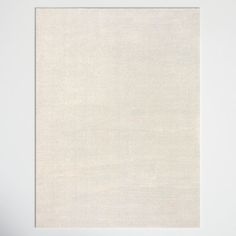 a white wall with a square frame hanging on it