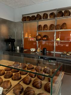 breads and pastries on display in a bakery