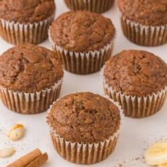 several chocolate muffins with nuts and cinnamon on the side