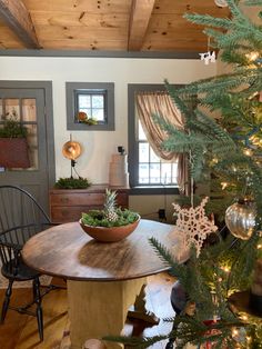 a christmas tree in a living room next to a table