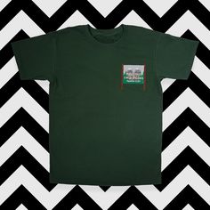 'Welcome to Twin Peaks' sign embroidered onto a high quality cotton t-shirt. Embroidered Green Tops For Streetwear, Embroidered Relaxed Fit T-shirt For Streetwear, Cotton T-shirt With Embroidered Graphics, Crew Neck, Graphic Tee With Embroidered Logo, Cotton T-shirt With Embroidered Graphics, Casual Green T-shirt With Embroidered Logo, Cotton Crew Neck Top With Embroidered Patch, Green Cotton Tops With Embroidered Logo, Green Cotton Top With Embroidered Logo