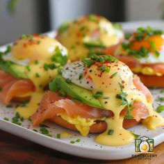 eggs, salmon and avocado on toast with hollandaise sauce in a white plate