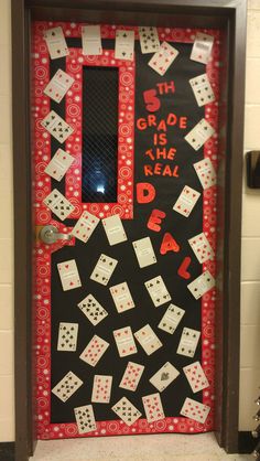 a door decorated with playing cards and dices on the front, says 5th grade is the real deal