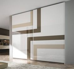 a living room filled with furniture next to a large glass wall mounted tv unit on top of a hard wood floor