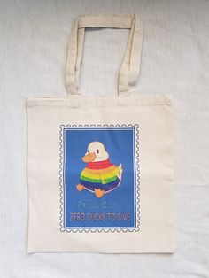 "Carry this canvas bag and show the world you're proud, cozy, and not in the mood to give out any ducks! Featuring a stylish duck in a rainbow sweater, this bag is for those No Ducks Given kind of day.    Fun Facts about your new favorite tote bag: .: Material: 100% cotton sheeting .: One size: Measuring at 15.75\"h x 15.25\"w and with a handle length of 21.5\" .: Lightweight and compact .: Reinforced handle stitching" Cute Multicolor Cotton Bags, Playful Cotton Bag For Gift, Playful Cotton Canvas Bag For Daily Use, Playful Cotton Bags For Everyday Use, Playful Cotton Rectangular Bag, Playful Cotton Rectangular Bags, Playful Everyday Cotton Bags, Playful Cotton Casual Bag, Playful Rectangular Cotton Bag