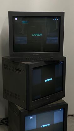 two televisions are stacked on top of each other