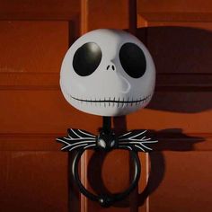 a skeleton head is mounted on the handle of a door