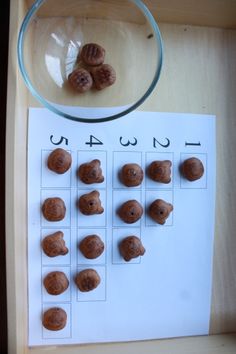 the numbers are made up of nuts in front of a magnifying glass bowl