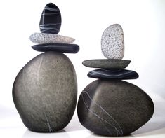 three rocks stacked on top of each other in the shape of an abstract rock formation