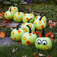 some pumpkins that have been painted to look like they are sitting in the grass