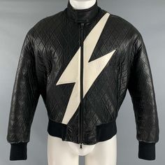 Neil Barrett Jacket In A Black And White Leather Fabric Featuring A Quilted Style, Oversized Bomber Fit, Lightning Bolt Design, And Zip Up Closure. Made In Italy.Very Good Pre-Owned Condition. Minor Signs Of Wear. Marked: S Measurements: Shoulder: 21 Inches Chest: 45 Inches Sleeve: 23.5 Inches Length: 24.5 Inches Sui Generis Reference: 128598 Category: Jacket More Details Brand: Neil Barrett Chest Size: S Size: S Gender: Male Color: Black Color 2: White Pattern: Quilted Fabric: Leather Style: Zi Retro Black Leather Jacket For Spring, Luxury Quilted Black Leather Jacket, Designer Black Leather Jacket For Spring, Designer Black Leather Jacket For Streetwear, Black Quilted Leather Jacket For Work, White Leather Fabric, Lightning Bolt Design, Glamrock Freddy, Neil Barrett