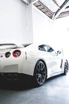 a white sports car parked in a garage