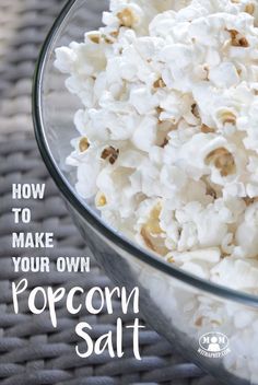 a glass bowl filled with popcorn on top of a table