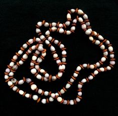 "Vintage 1970 White and Wood Tone Bead Necklace Beautiful bead necklace with alternating off-white and brown flat disc beads This acrylic casual earth tone necklace is a 52\" single stand with no clasp." White Jewelry With Oval Wooden Beads, White Jewelry With Wooden Beads, White Jewelry With Round Wooden Beads, Vintage White Beaded Necklace With Wooden Beads, Brown Shell Necklace With Round Beads For Gift, Vintage White Hand-strung Necklaces, Vintage White Oval Bead Necklaces, Vintage White Oval Beads Necklaces, Vintage White Beaded Shell Necklace